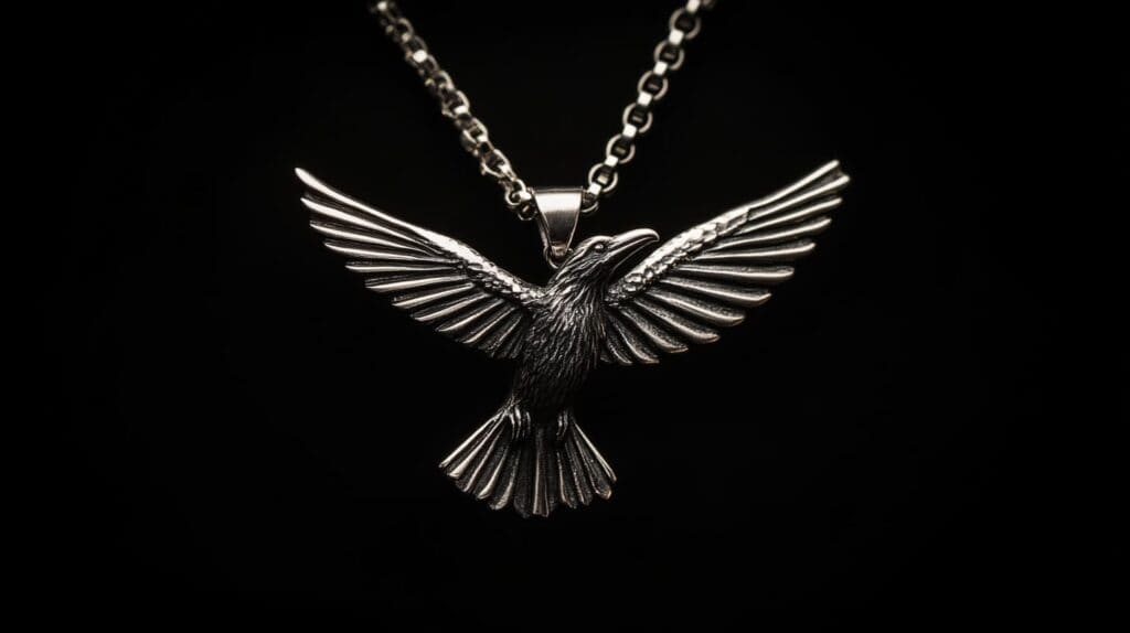 Silver pendant depicting a raven in flight with outstretched wings, symbolizing freedom, transformation, and spiritual journeys.