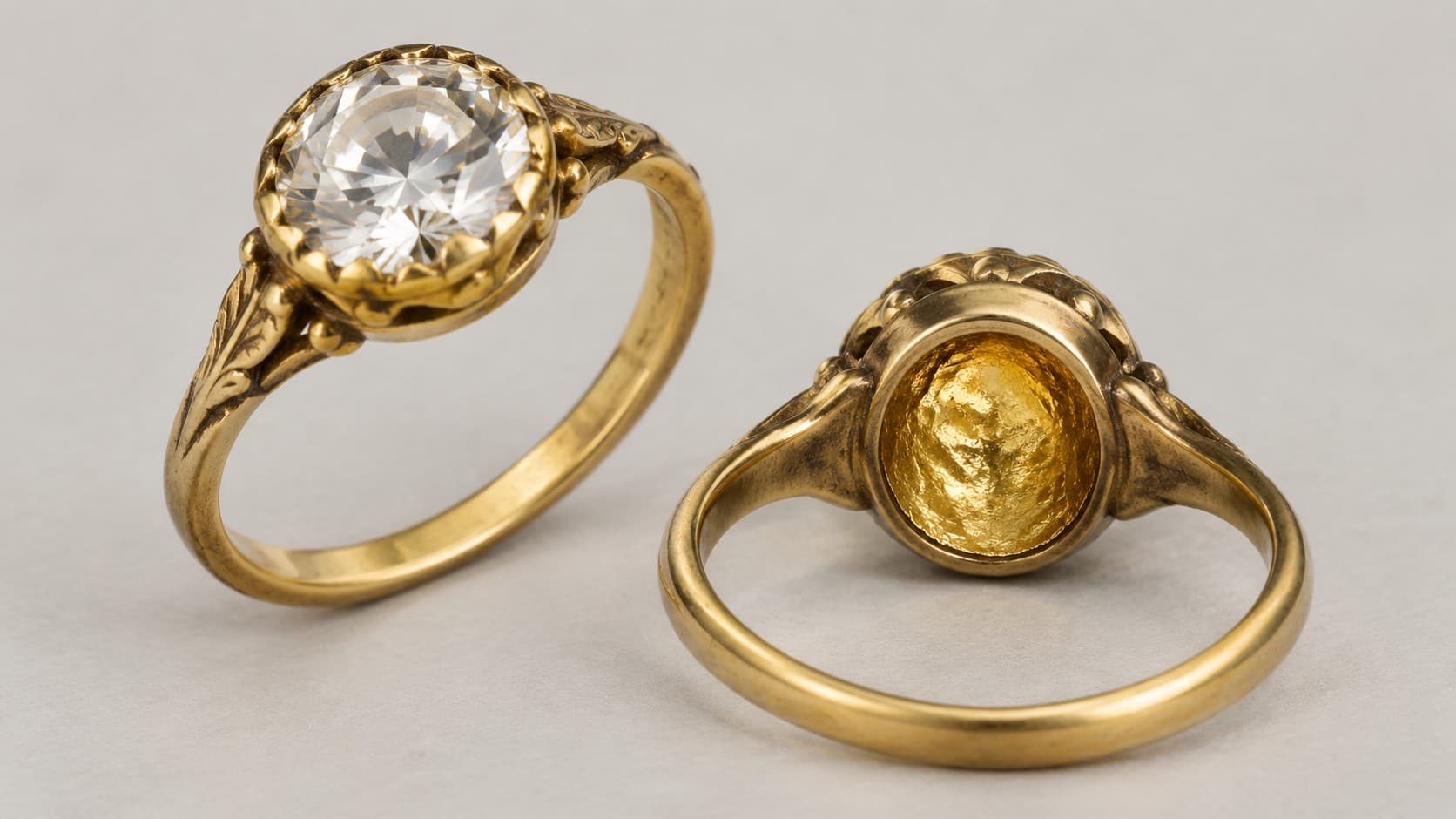 Antique gold ring with a round cut diamond, shown from the front and from behind with its closed foil backed setting