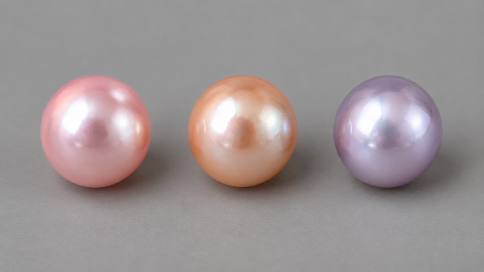 Pink, peach, and lavender freshwater pearls in a row