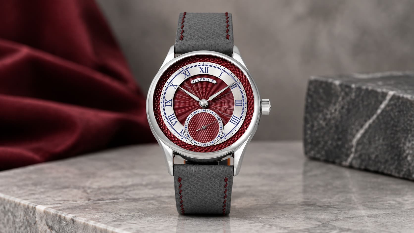 Garrick S7 Timepiece with red guilloche dial, Roman numerals, and sub-seconds display