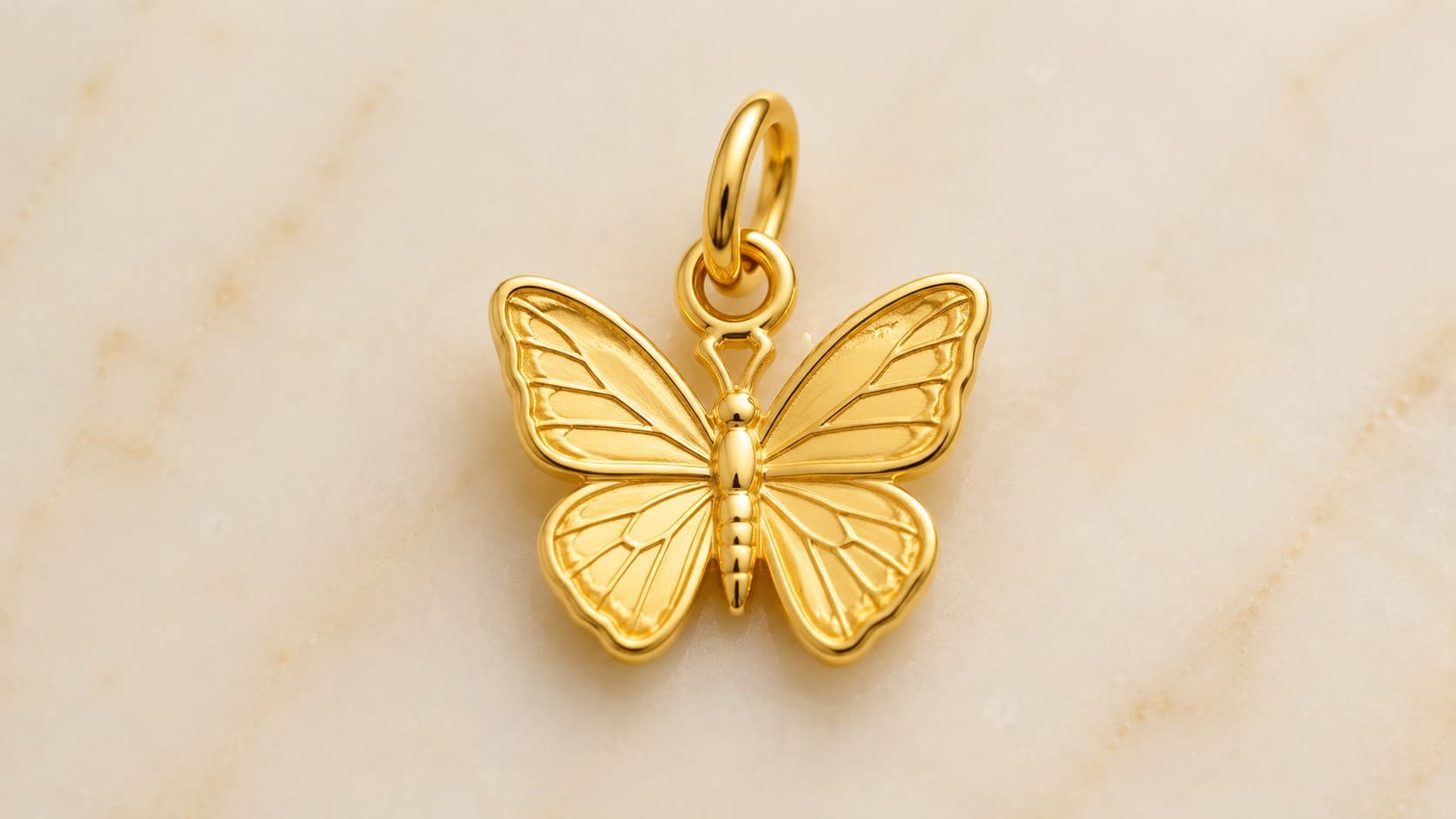 Gold butterfly charm symbolizing transformation