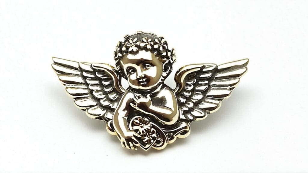 Gold cherub angel brooch with intricate detailing, featuring a childlike angel with open wings, floral crown, and a small heart design.