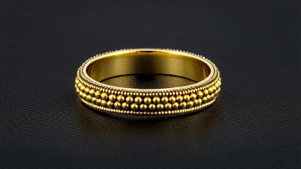 Close-up of a gold ring featuring intricate granulation work, with rows of tiny gold spheres creating a textured band.