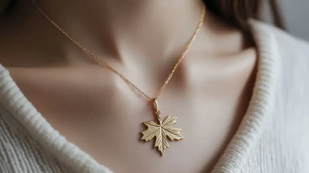 Gold maple leaf pendant necklace symbolizing growth and new beginnings, perfect for adding a natural touch to any outfit.