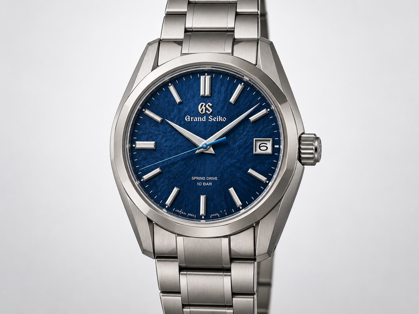 Grand Seiko Spring Drive watch with a textured blue dial and titanium bracelet