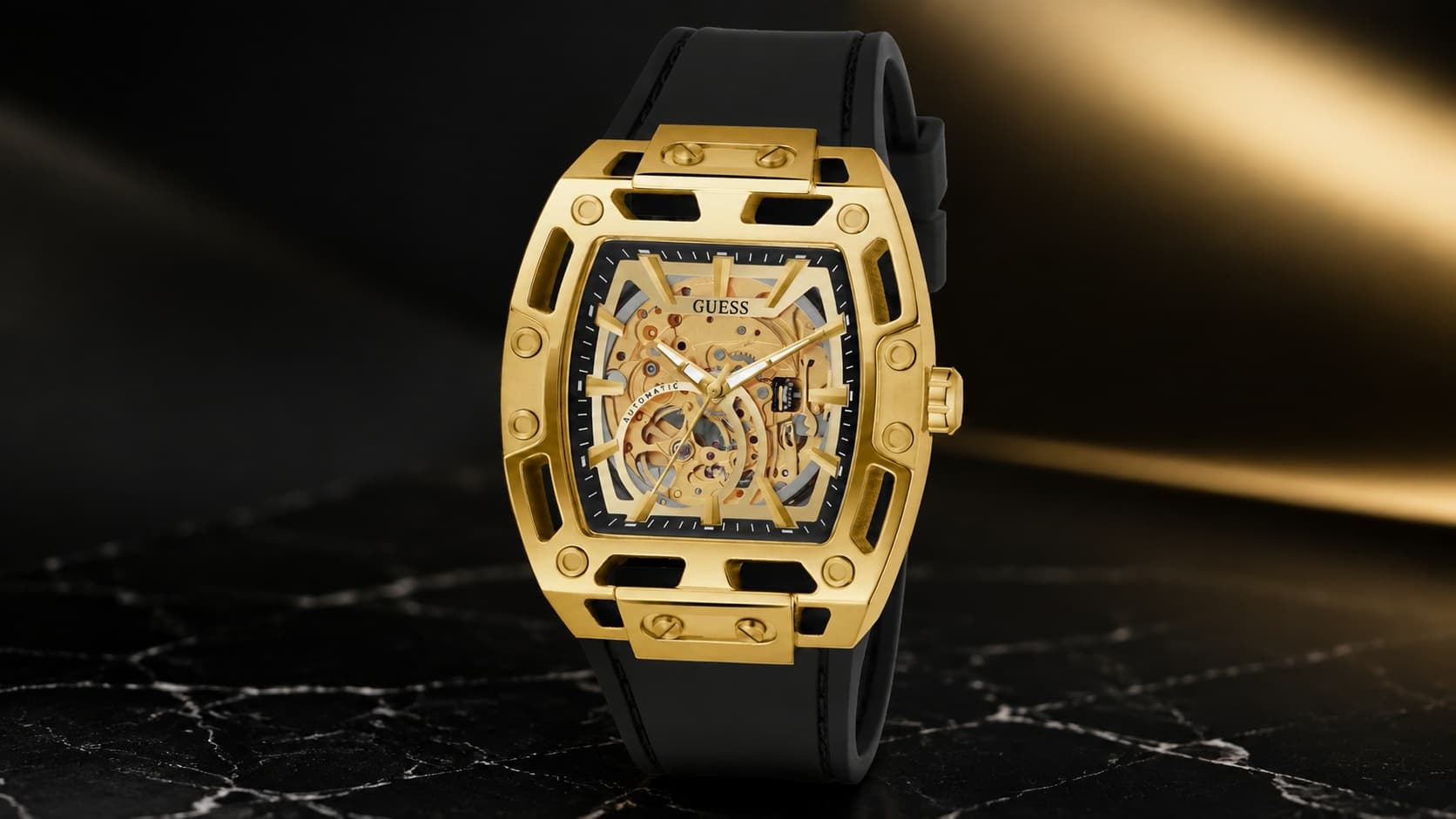 Guess men's black and gold-tone automatic watch with skeleton dial and silicone strap