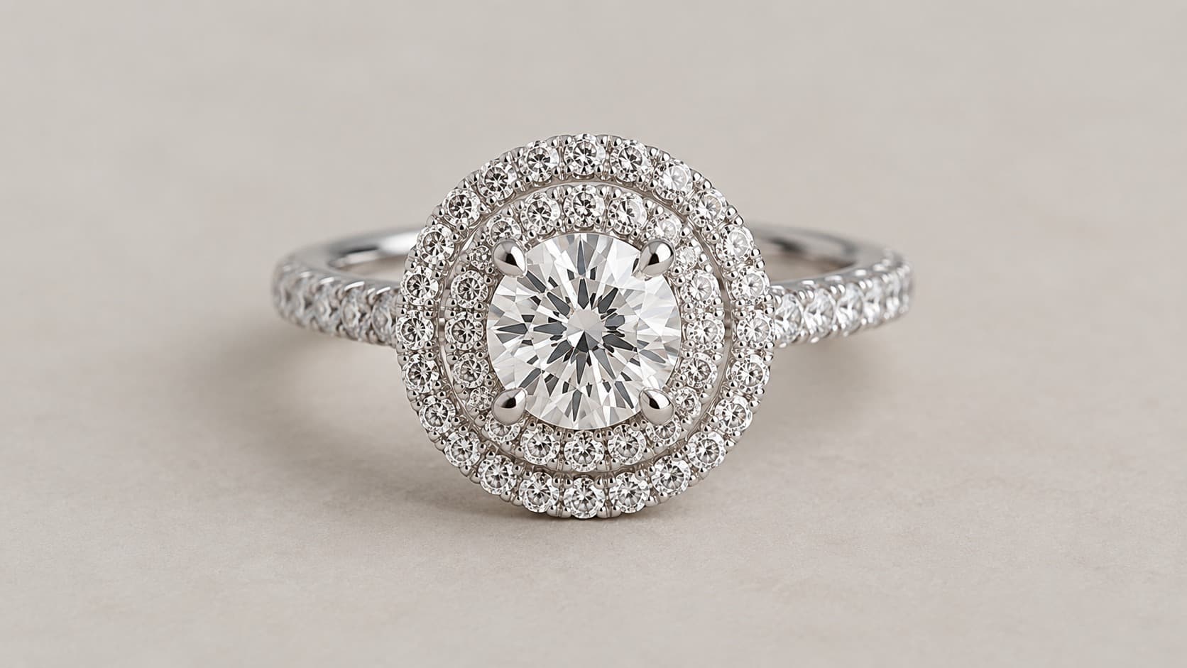 Double halo engagement ring with a round center diamond surrounded by two rows of pavé diamonds