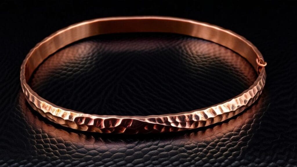 A handcrafted hammered copper bracelet highlighting the effects of quenching and annealing in jewelry metalworking.