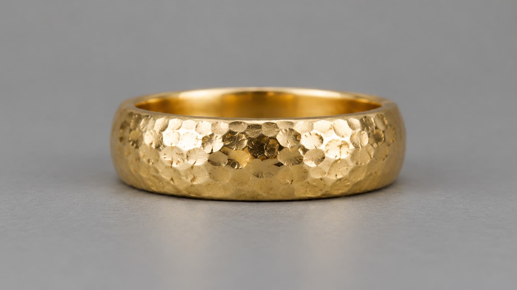 Gold ring with a hammered dimpled finish