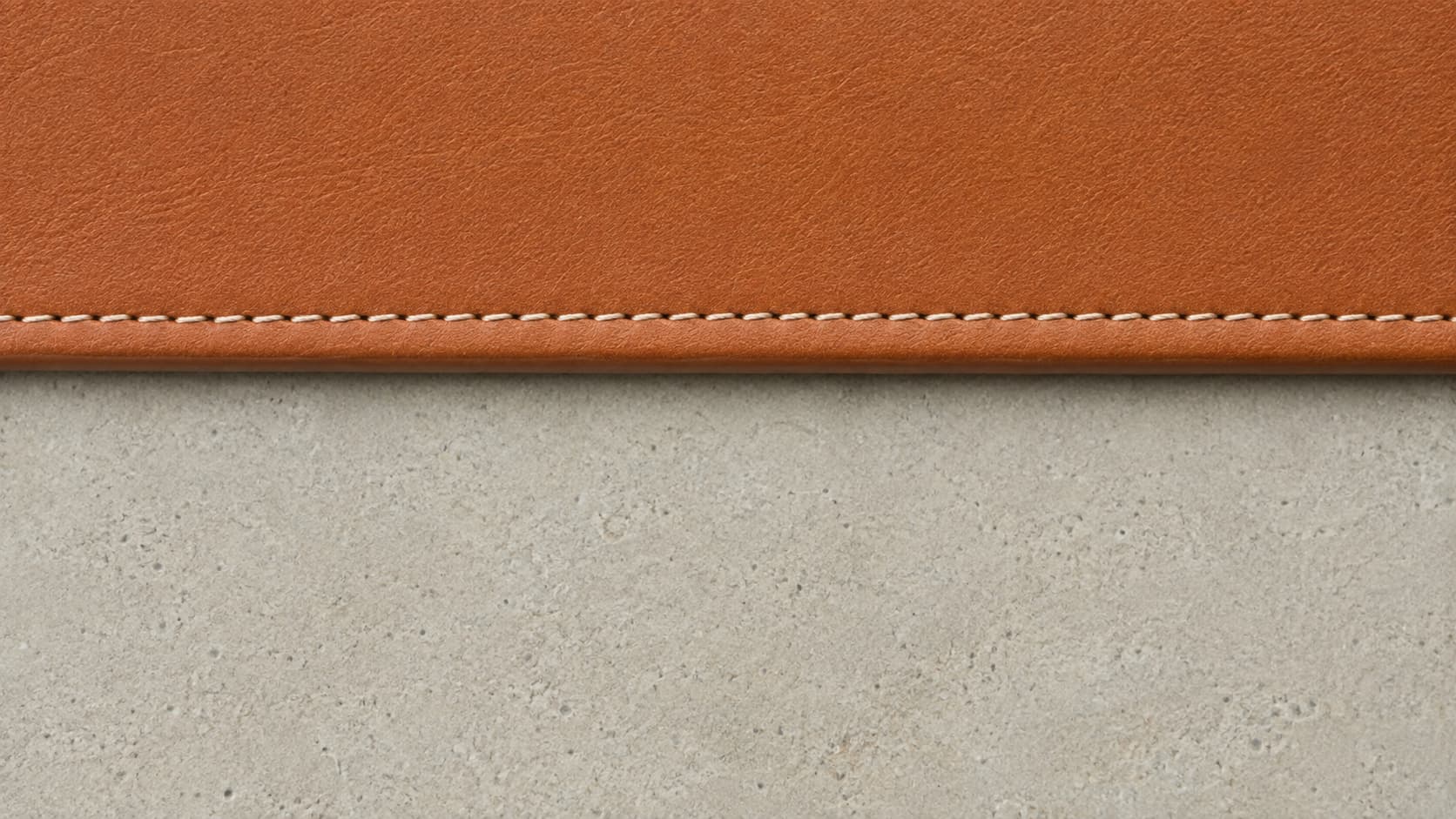 Straight, evenly spaced stitch line along a leather handbag edge