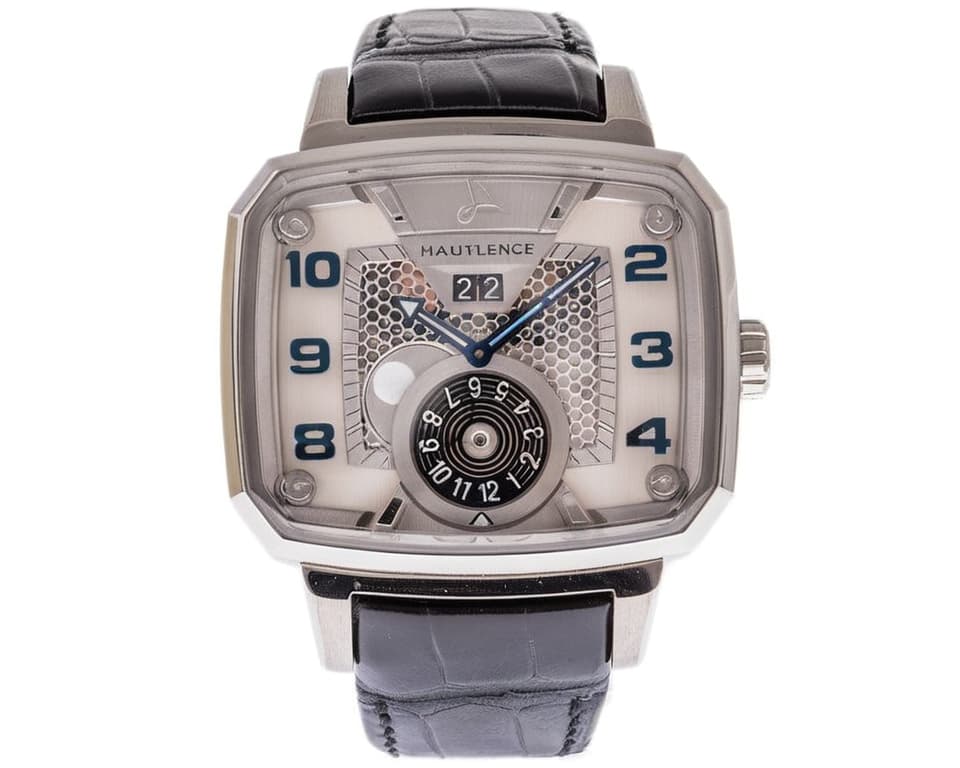 Hautlence watch dial with honeycomb texture, date window, and blue hour and minute hands