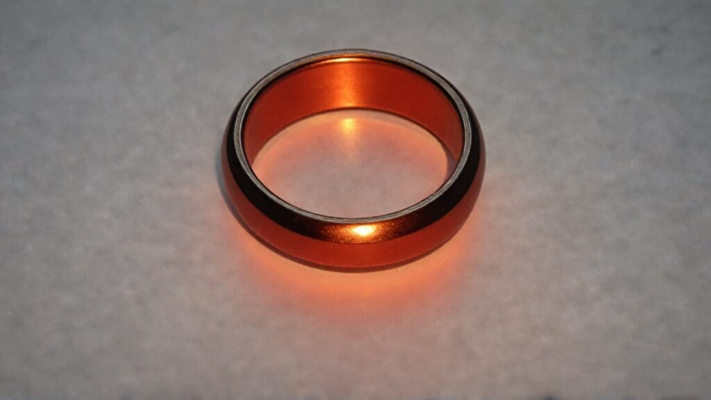 Metal ring glowing red hot demonstrating dangerous heat buildup that causes burns in saunas