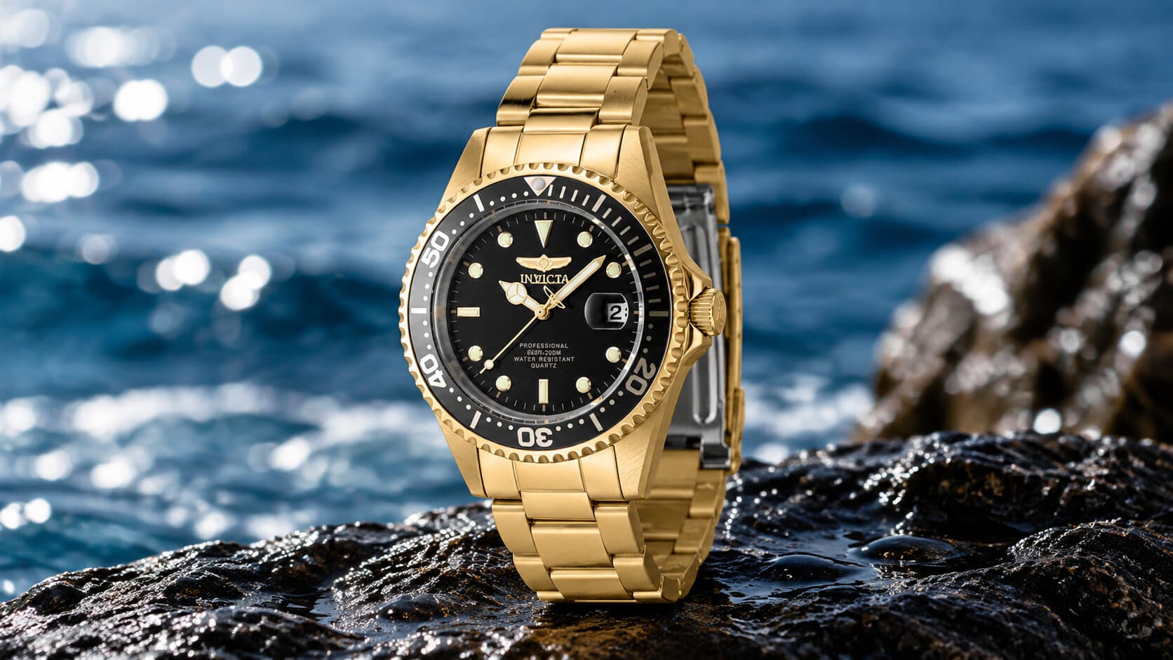 Invicta Pro Diver 8936OB gold dive watch with black dial on ocean rocks