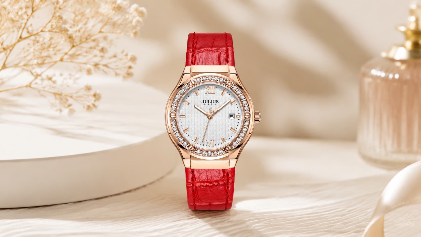 Julius JA-1395 women's rose gold watch with a crystal-lined bezel and red leather strap