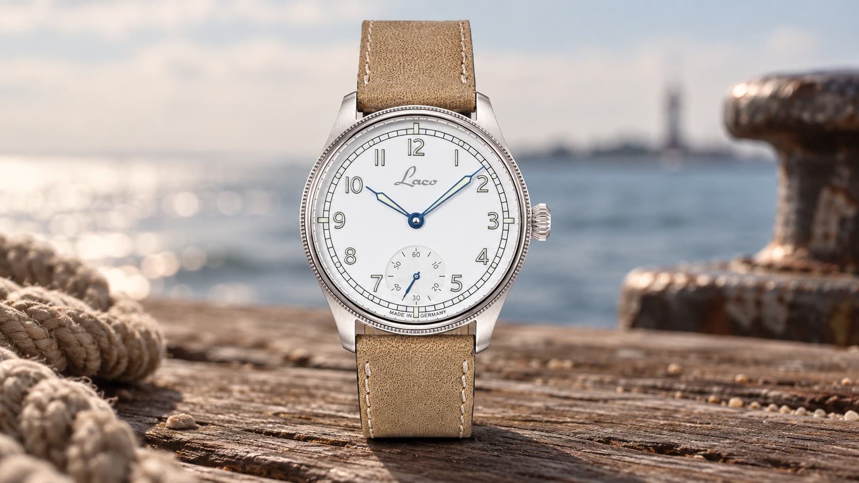 Laco Cuxhaven 42.5 navy pilot watch with tan leather strap on a wooden dock by the sea