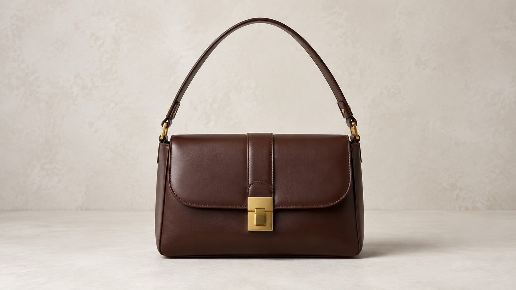 Structured dark brown leather shoulder bag with a top handle