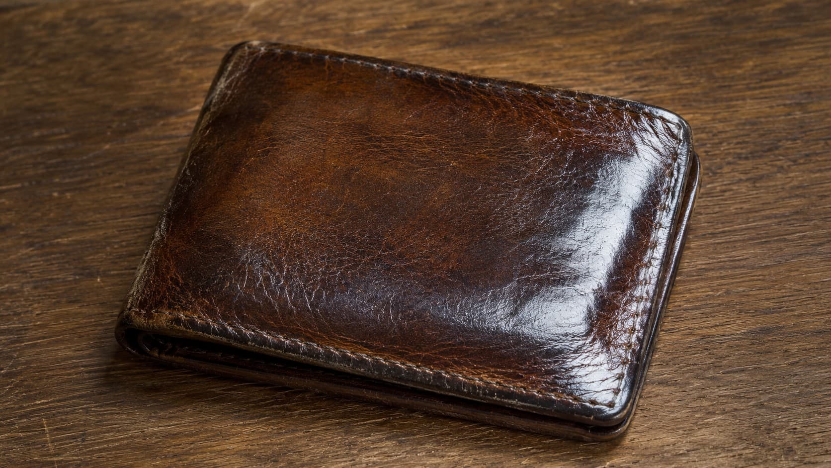 Worn brown leather wallet with rich patina from daily use