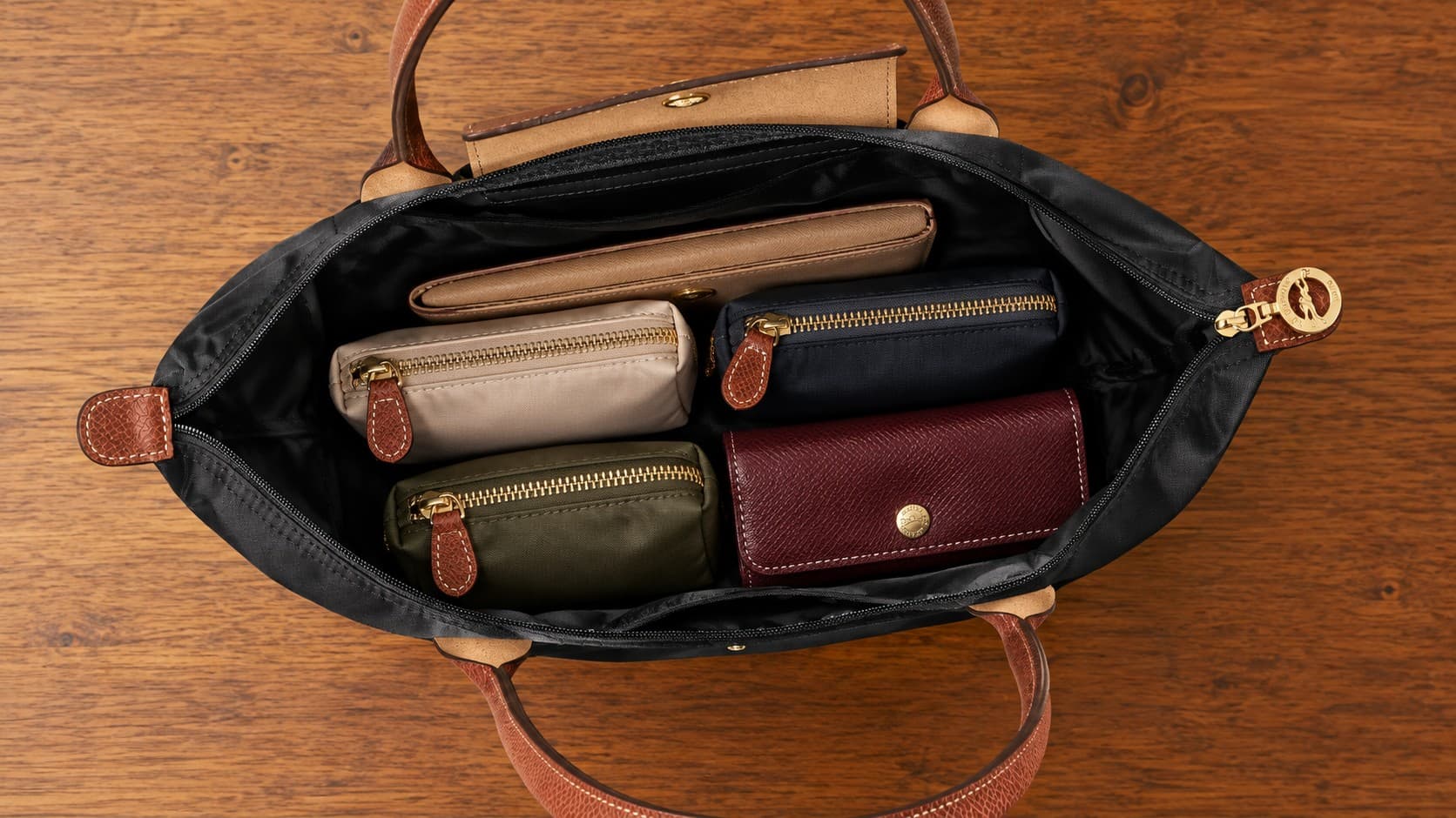 Longchamp Le Pliage tote bag interior organized with small zippered pouches and a wallet