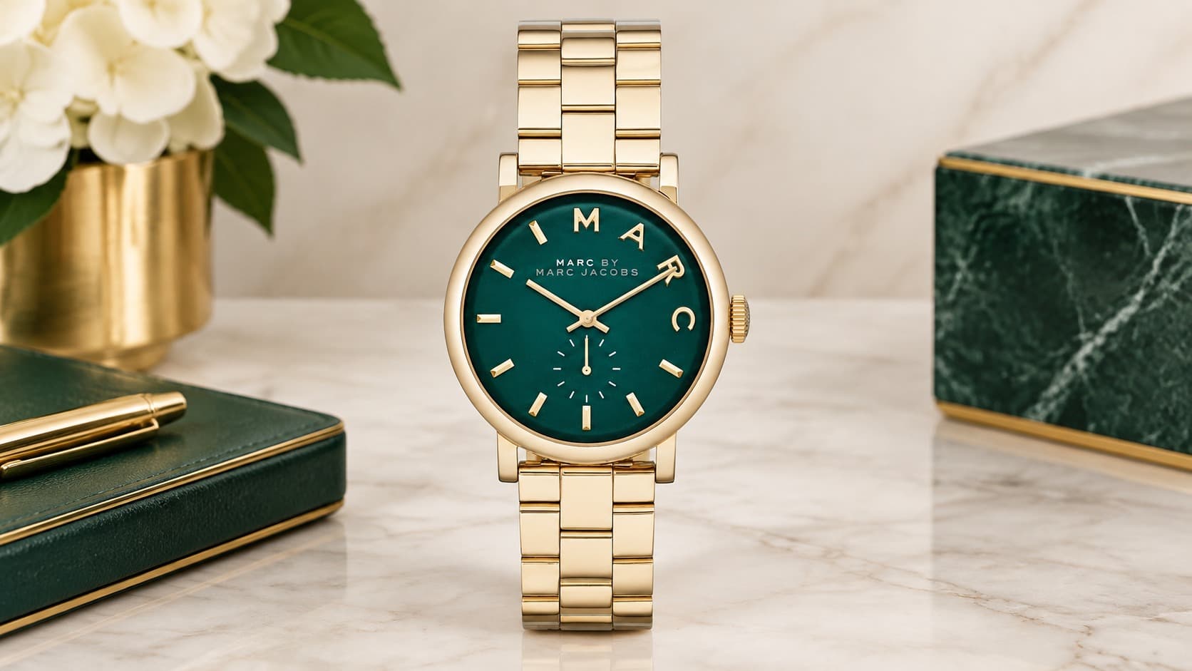 Marc Jacobs Baker MBM3245 gold-tone watch with green dial on a marble desk