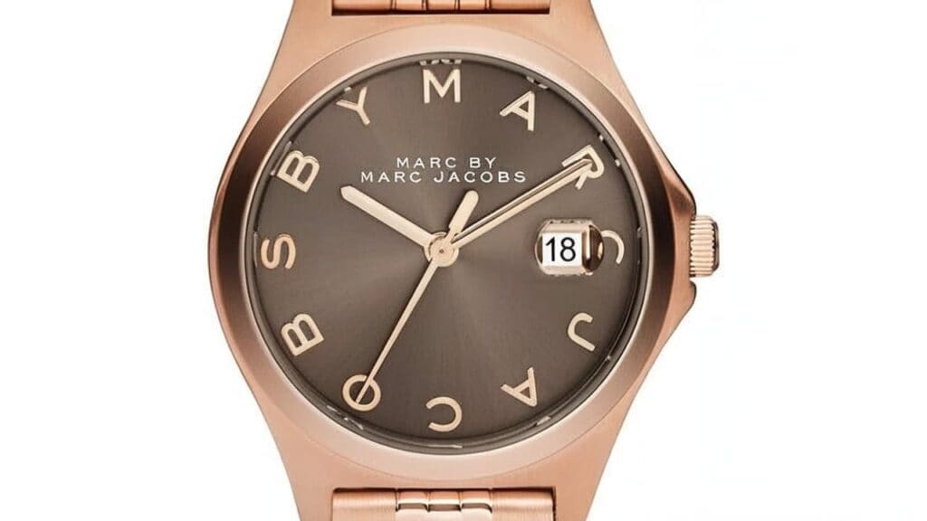 Marc Jacobs watch in rose gold finish with brown dial and date display featuring signature MARC lettering