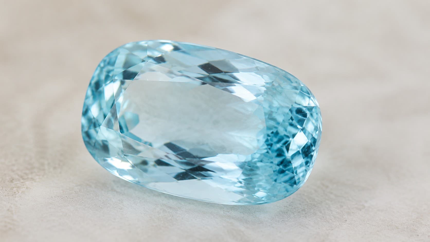 Cushion-cut aquamarine gemstone, the March birthstone, in pale blue color