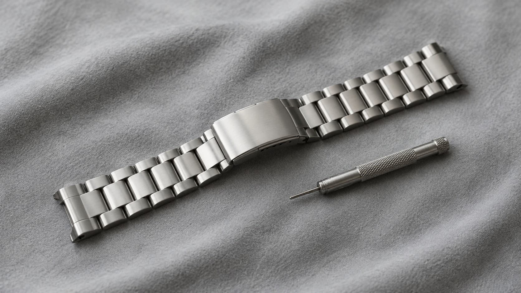Stainless steel watch bracelet with a spring bar tool used for link removal