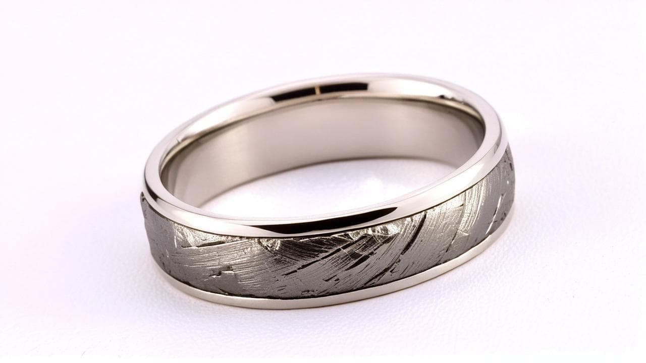 White gold band inlaid with a textured meteorite stripe