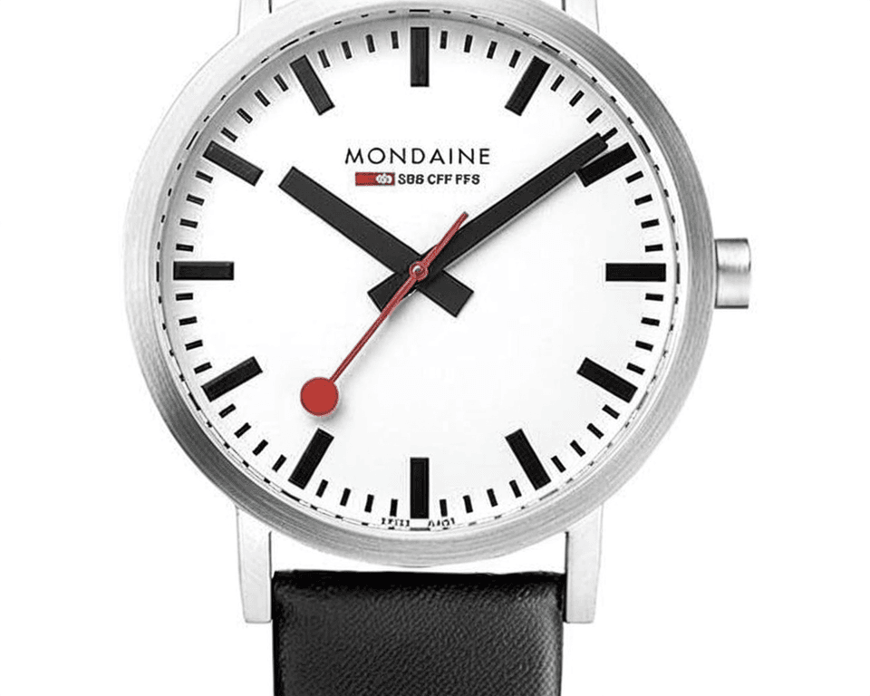 Mondaine Swiss railway watch featuring clean white dial, distinctive red lollipop second hand, stainless steel case, and black leather strap showcasing minimalist Swiss design