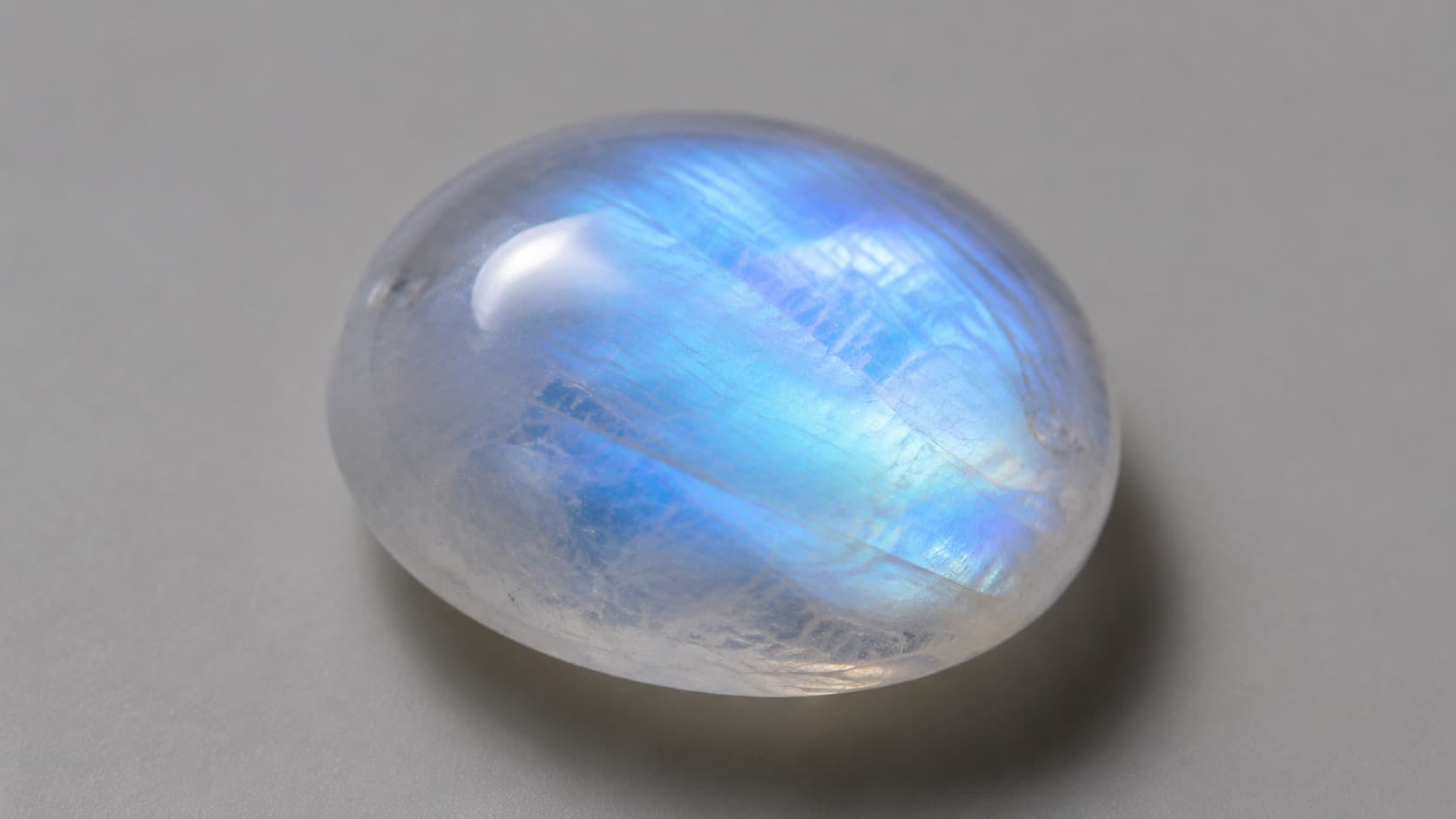 Moonstone cabochon with blue glow effect called adularescence