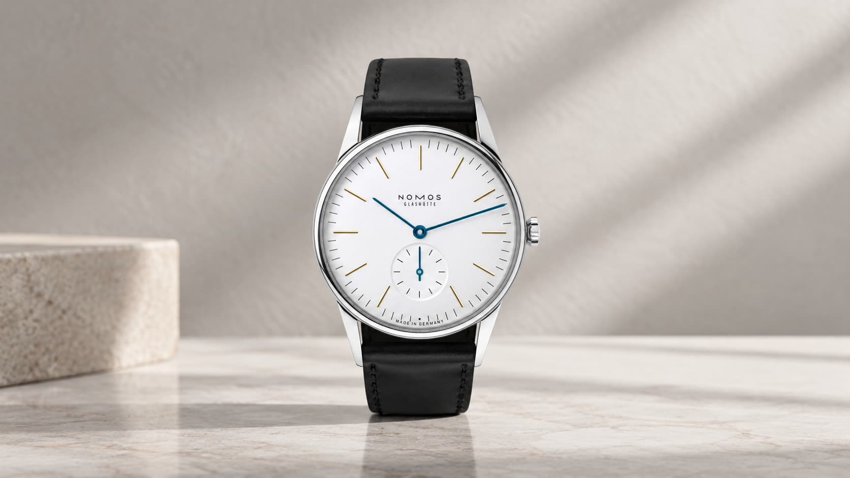NOMOS Glashütte Orion watch with a white dial and black leather strap