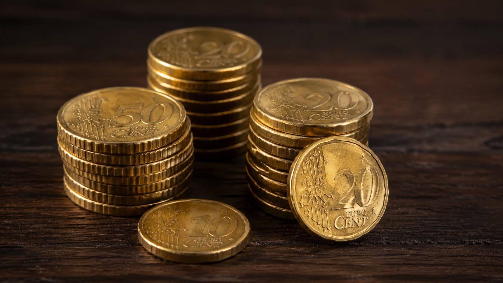 Close-up of Nordic gold euro cent coin stacks in 50, 20, and 10 cent denominations