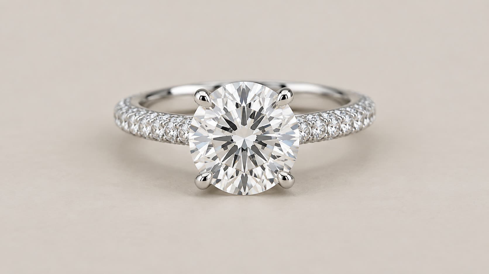 Round diamond engagement ring with a pavé diamond setting along the band