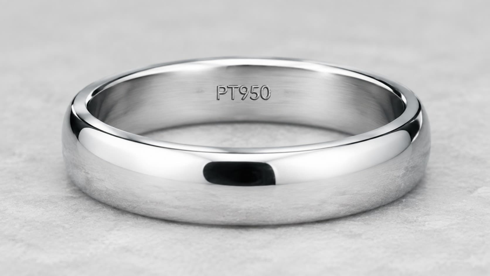 Close-up of a PT950 platinum purity stamp engraved inside a ring band