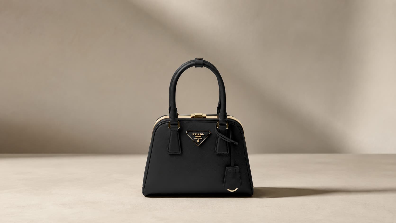Black Prada Saffiano leather mini bag with gold triangle logo and top handle