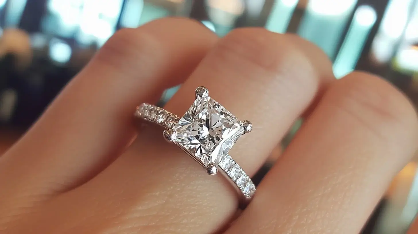 Princess-cut diamond engagement ring with a pave band worn on a hand