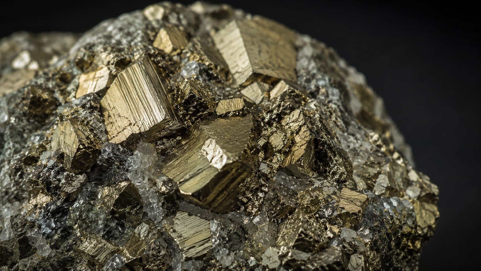 Close-up of pyrite crystal cubes showing natural metallic gold shine
