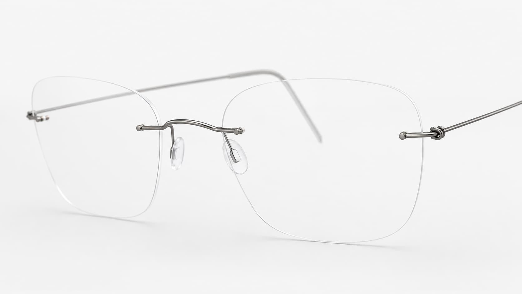 Rimless glasses with thin titanium frame and screw mount on the lens