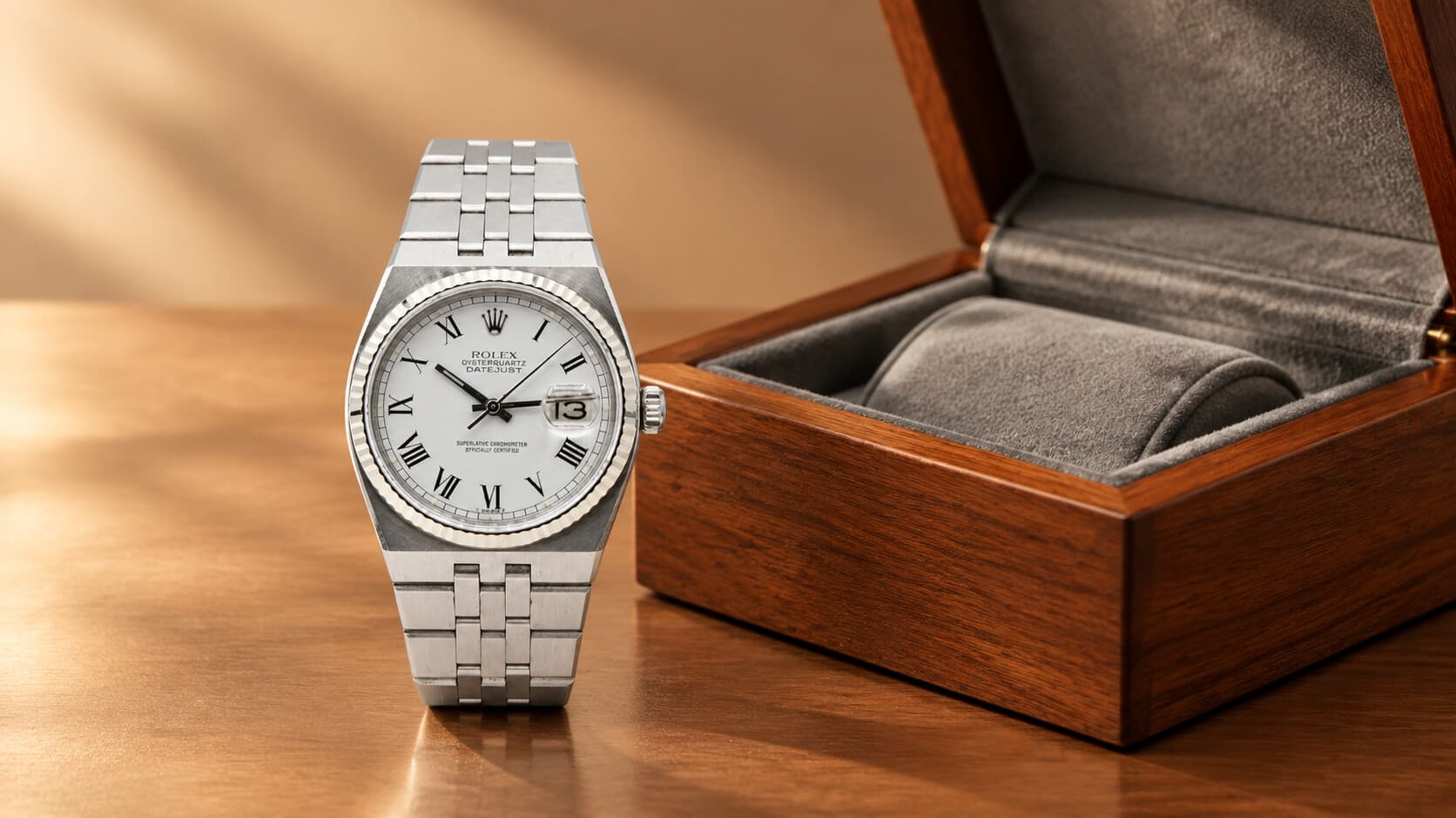 Rolex Datejust Oysterquartz steel watch standing next to an open wooden watch box lined with grey felt
