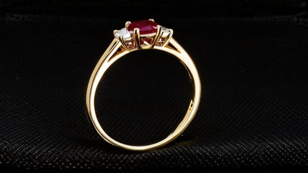 A vibrant ruby engagement ring set in a yellow gold band with diamond side stones, symbolizing passion and romance.