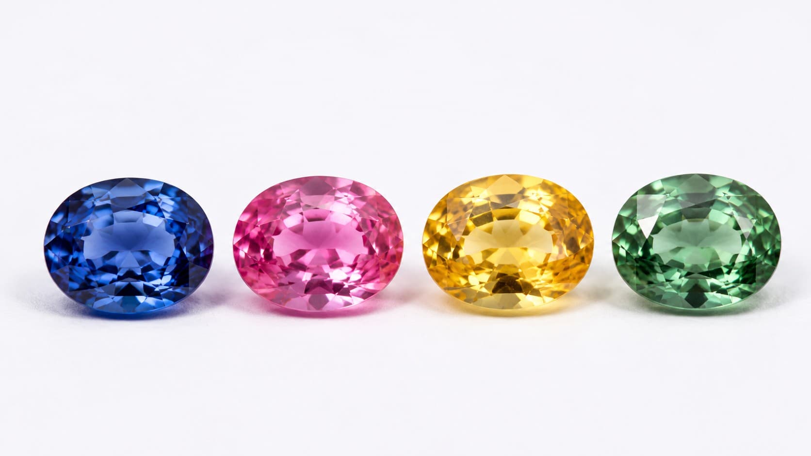 Blue, pink, yellow, and green sapphires showing the color varieties of the September birthstone