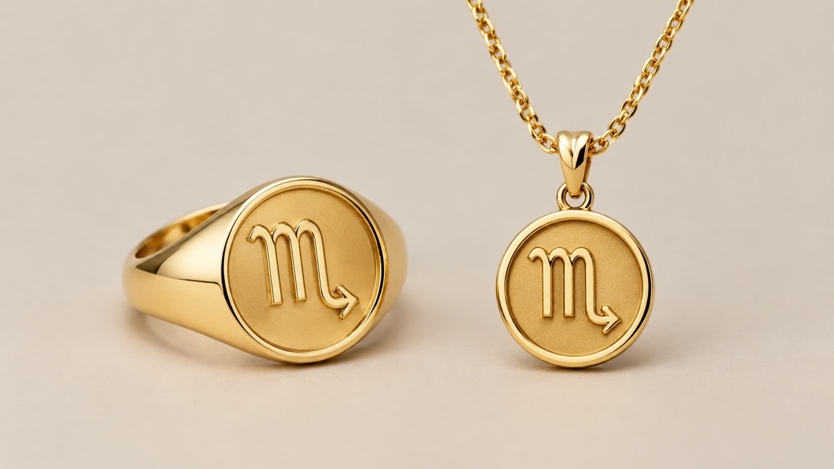Gold signet ring and pendant necklace featuring the Scorpio zodiac glyph