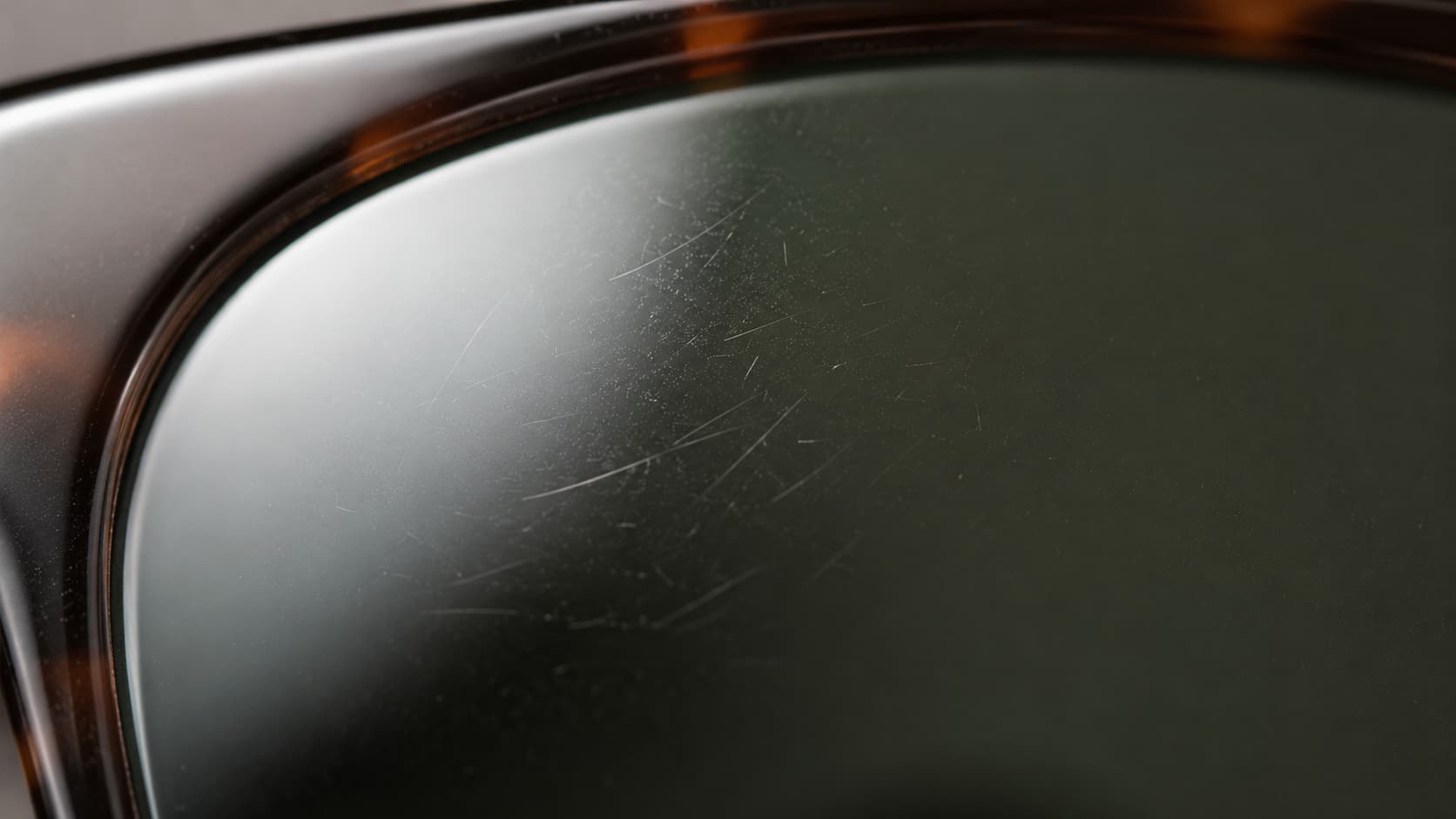 Close-up of fine scratches on a sunglasses lens