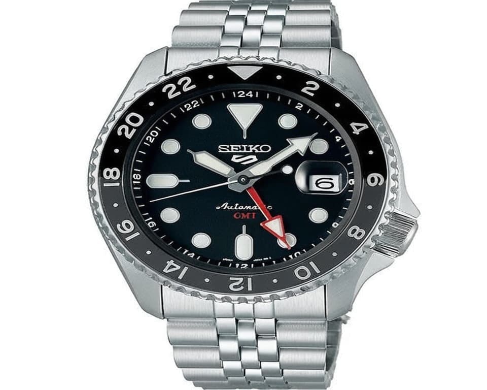 Seiko automatic GMT watch with black dial, red GMT hand, and 24-hour bezel showing dual time zone functionality