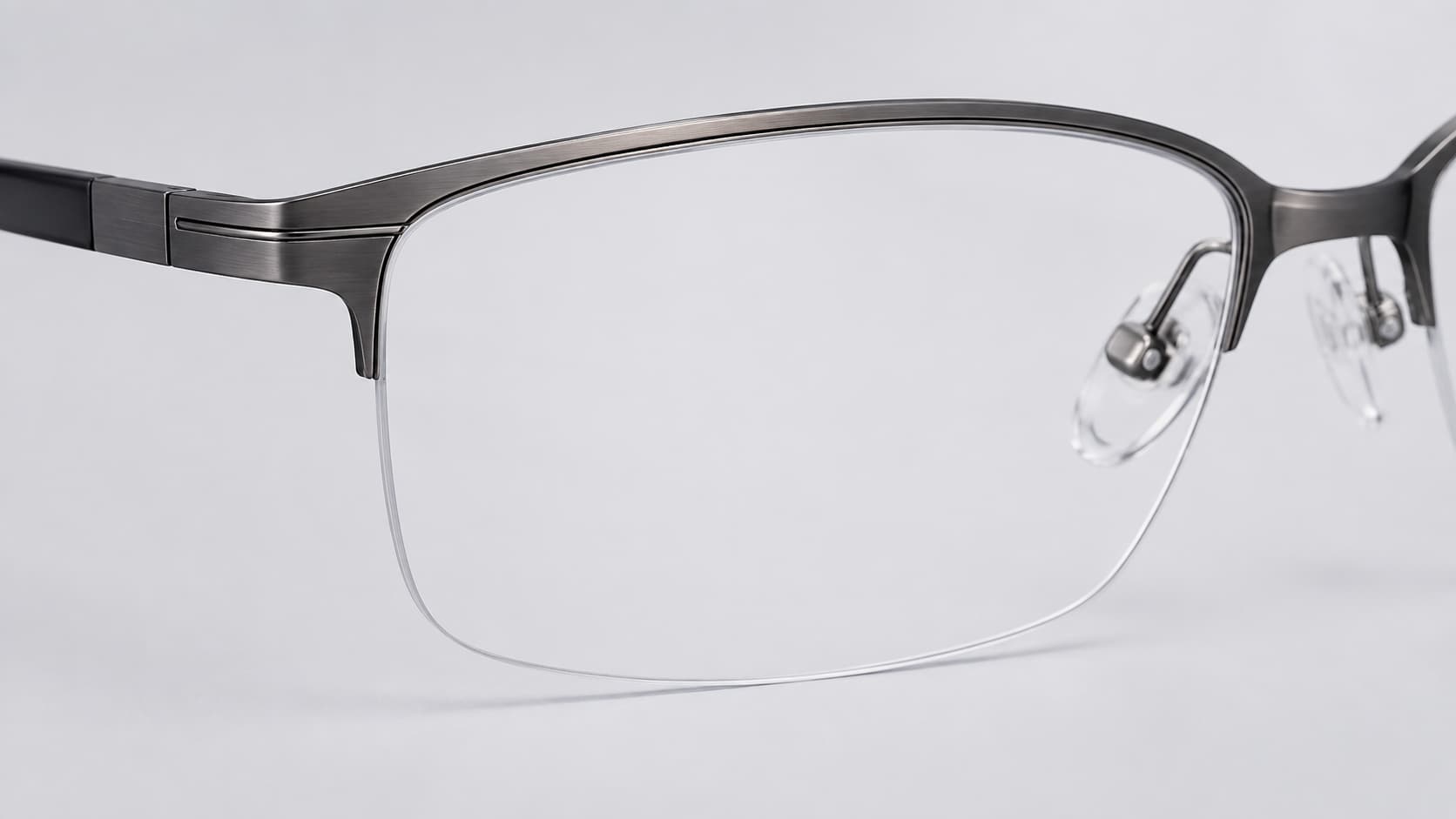 Semi-rimless glasses showing metal top rim and nylon cord along the bottom lens edge