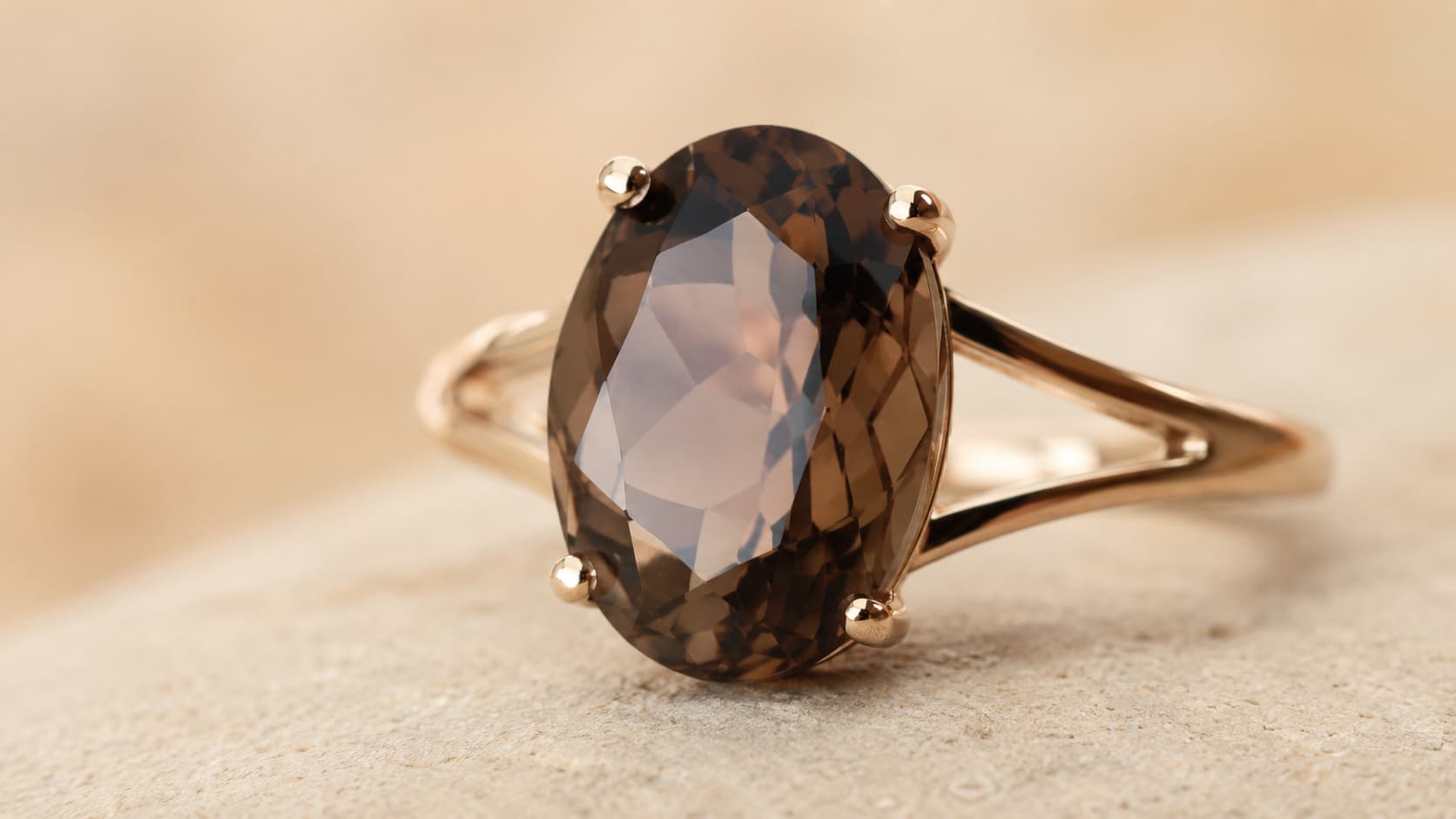 Oval cut smoky quartz gemstone ring set in gold prongs