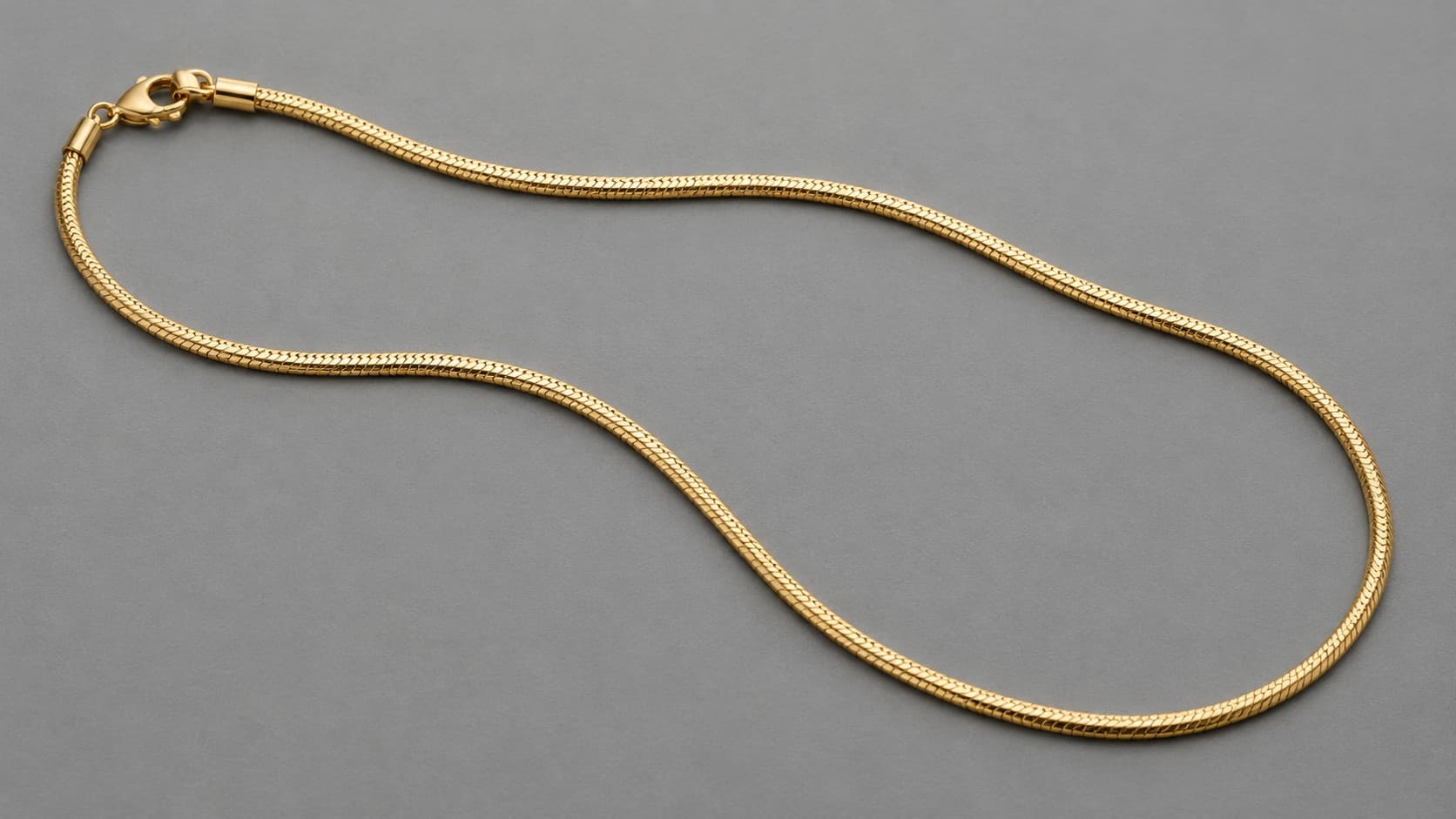 Gold snake chain necklace with a smooth rounded surface
