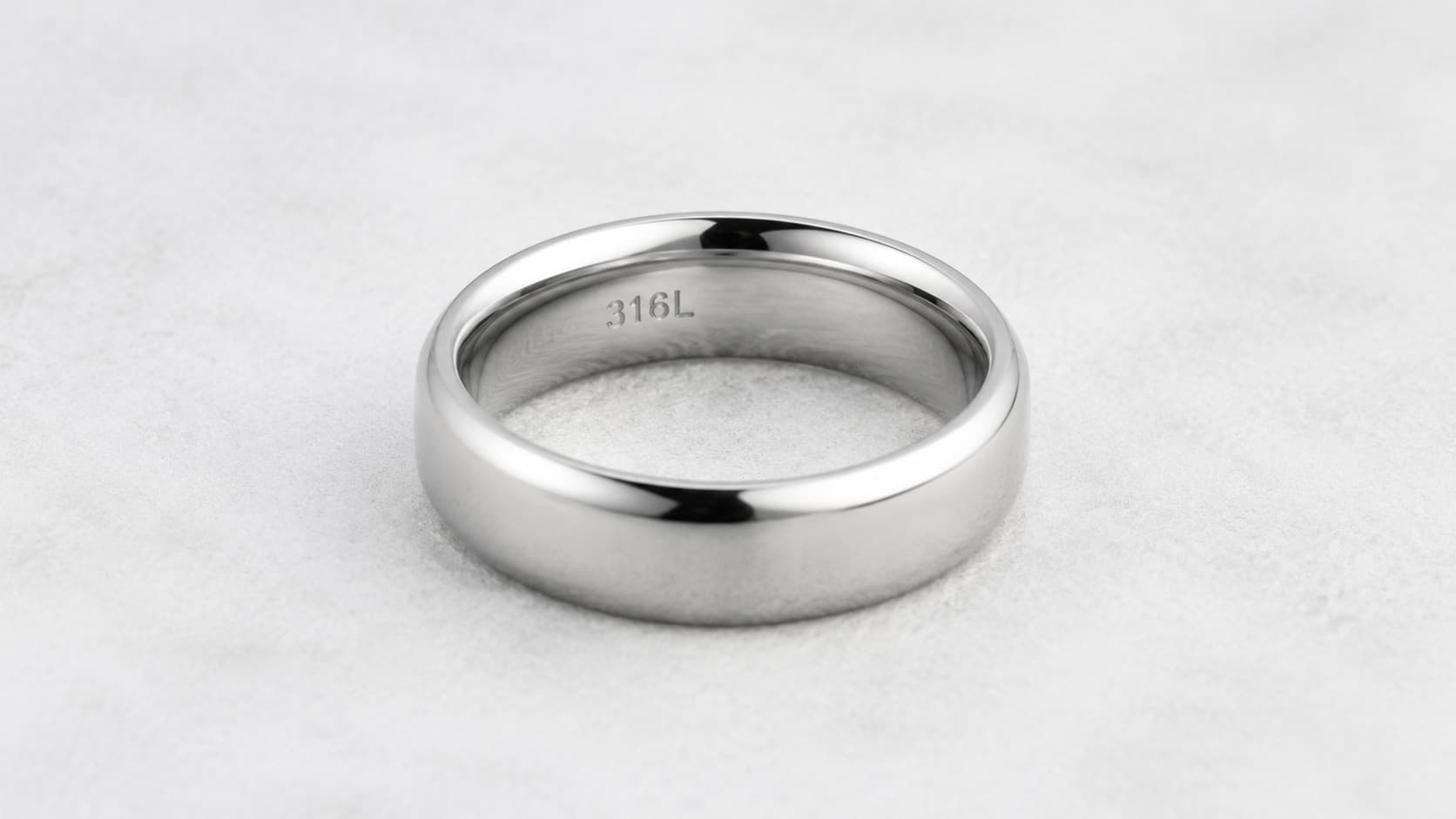 Polished stainless steel ring showing 316L stamp engraved inside the band