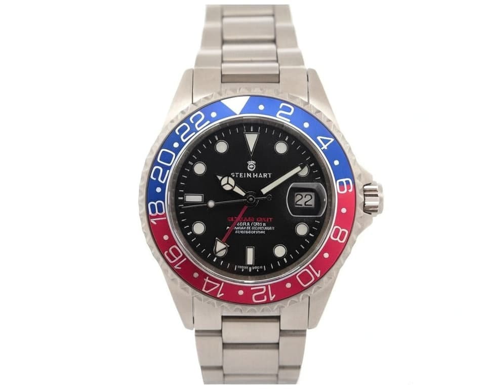 Steinhart GMT watch with blue and red Pepsi bezel, black dial, and stainless steel bracelet showing dual time zone functionality