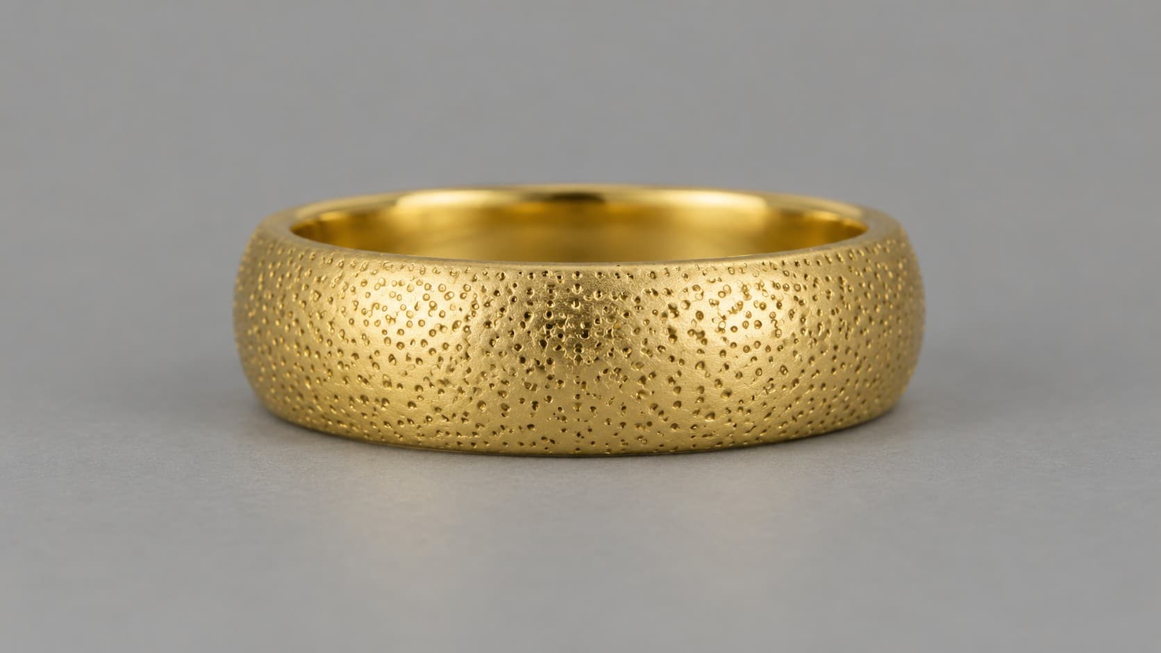 Gold ring with a small dotted stipple finish