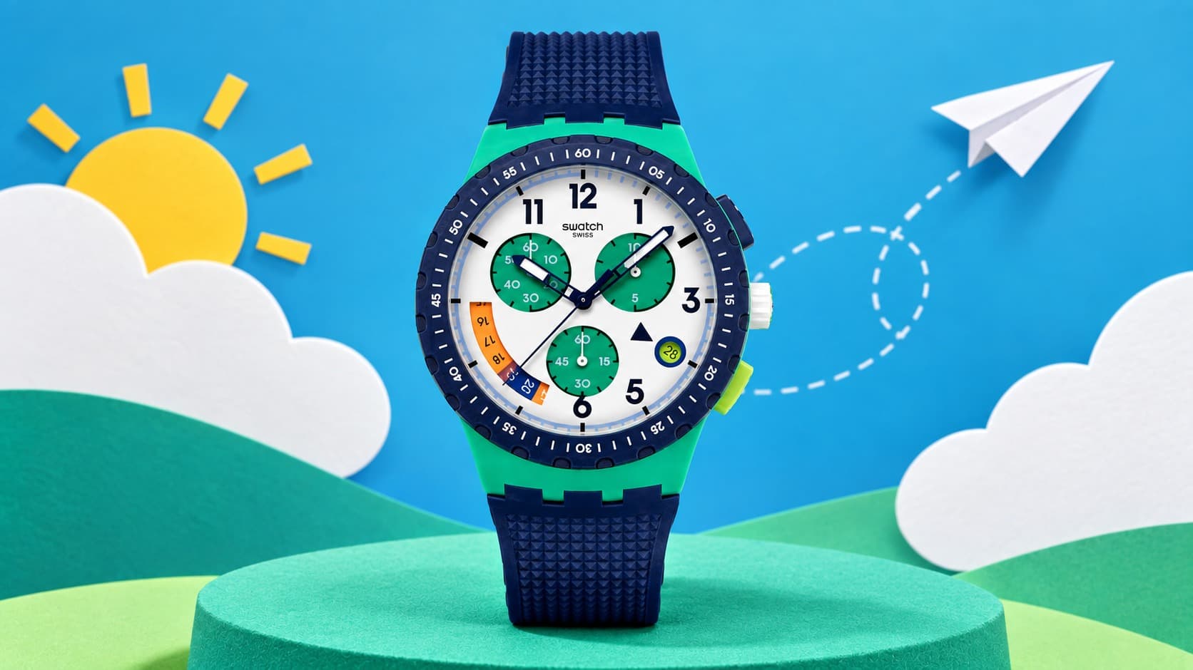 Swatch Time Flies chronograph watch with a navy and green case set against a paper-craft sky